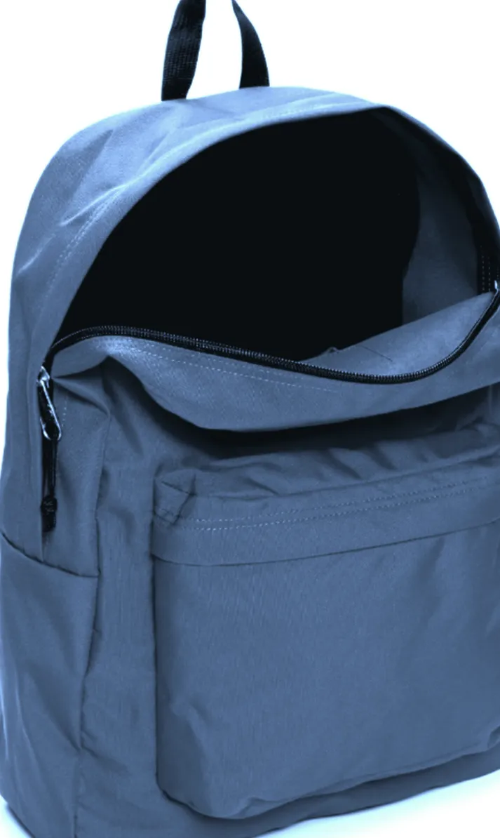 A detailed view of a plain navy blue school backpacks main compartment open showing the zipper and front utility pocket